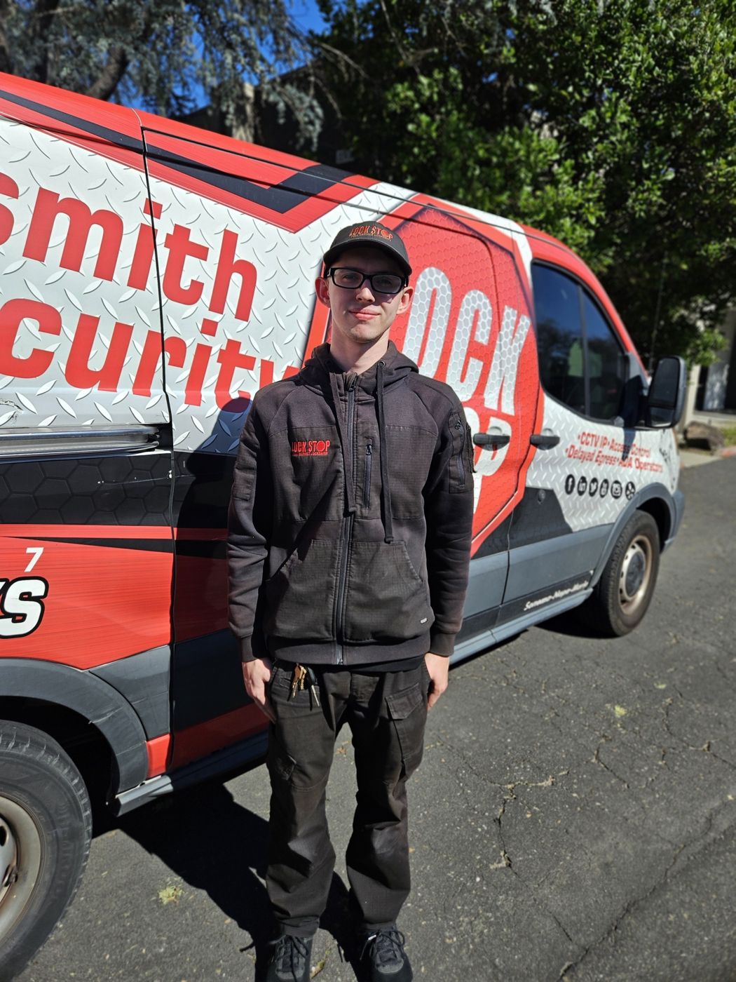 Lock Stop and Key technician beside the company van